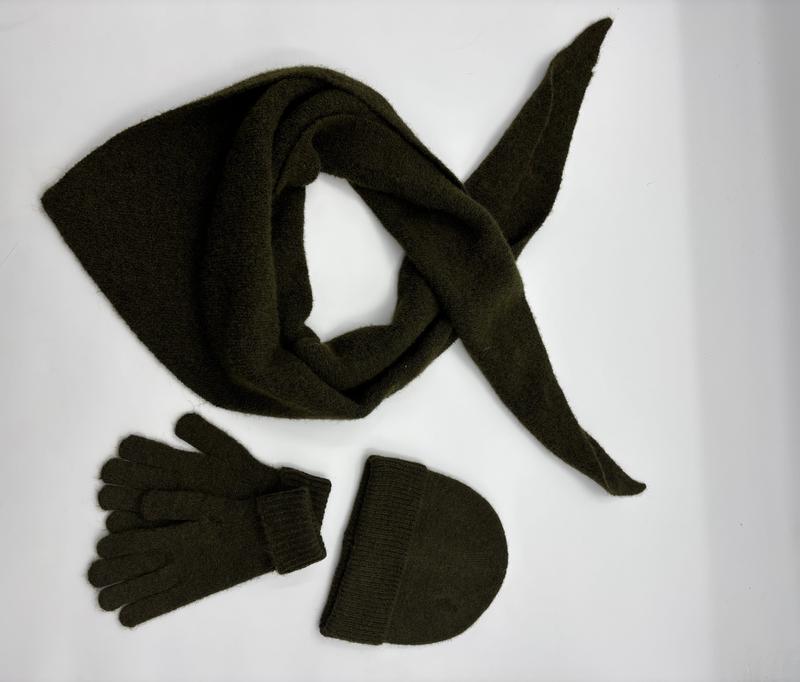 Olive green knit winter accessories set with triangle scarf, matching gloves and beanie hat on white background