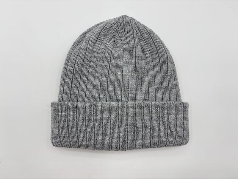 Heather grey ribbed knit cuffed beanie hat laid flat on white background, showing fine rib texture and folded brim