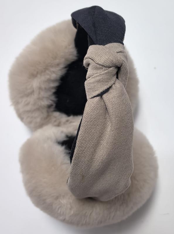 White plush snowman earmuffs with red velvet ear cups, orange carrot nose, and decorative red bow headband