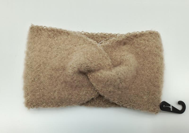 Soft camel-colored fuzzy knit headband with twisted knot detail and subtle gold metallic thread, laid flat on white background