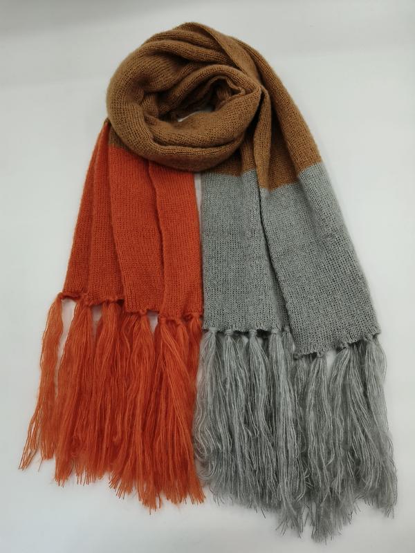 Color block knit scarf in rust orange, grey, and camel with long fringe ends, laid flat on white background