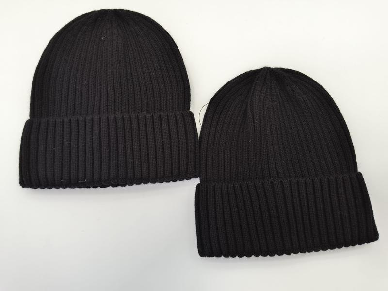 Two black ribbed knit beanie hats with cuffed brims displayed flat on white background, one larger and one smaller