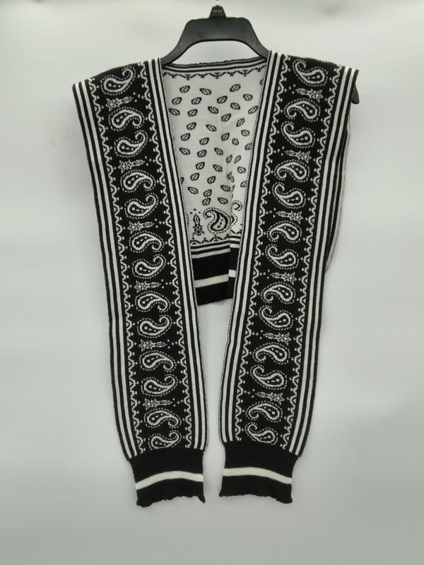Black and white paisley patterned knit sleeveless cardigan vest with stripe trim, displayed open on hanger
