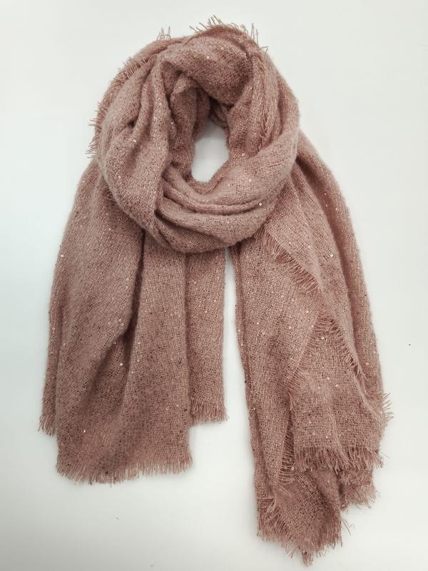 Dusty rose pink soft knit oversized scarf with scattered sequins and frayed fringe edges, loosely coiled on white background