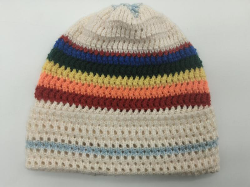 Handknit cream beanie hat with rainbow stripes in red, orange, yellow, green and blue on open mesh knit base