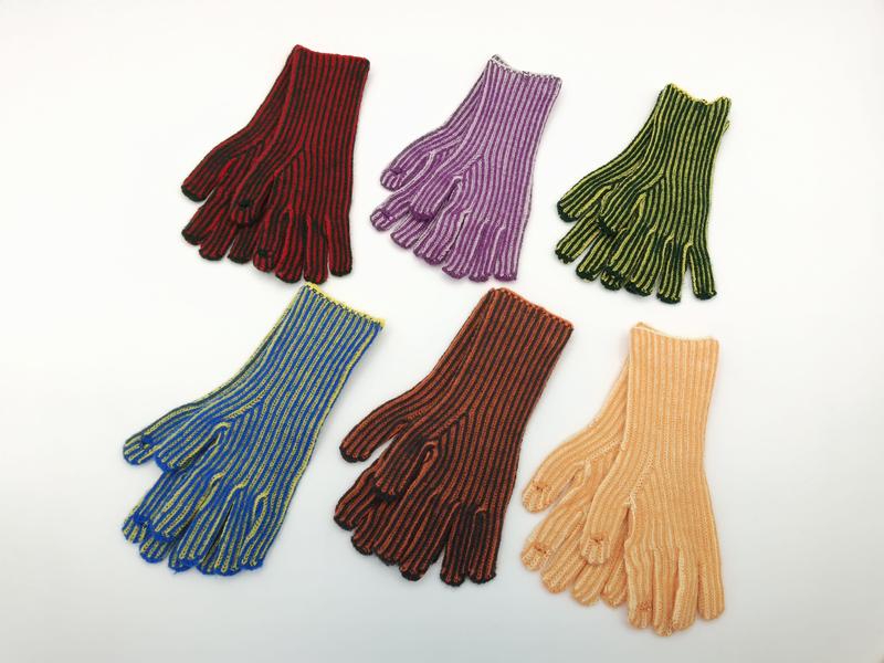 Six pairs of ribbed knit striped gloves in red, purple, green, blue, brown, and peach laid flat on white background