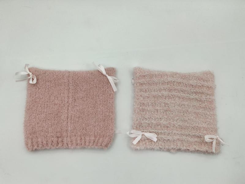 Two blush pink fuzzy knit boot cuffs with white satin ribbon bows, shown side by side on white background