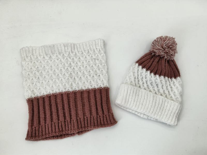 Knitted winter set with cream and mauve cowl neck scarf featuring diamond pattern and matching pom-pom beanie hat on white background