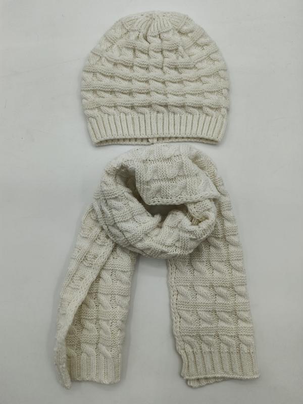 Cream white cable knit beanie hat and matching long scarf set laid flat on white background
