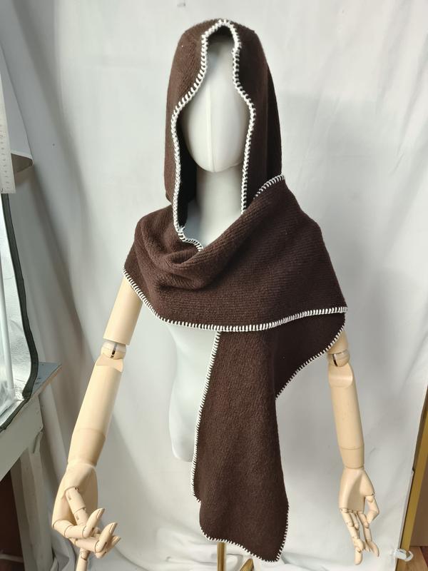 Dark brown knitted hooded scarf wrap with white blanket stitch border displayed on mannequin with wooden arms