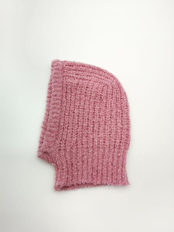 Pink chunky ribbed knit balaclava ski mask hood laid flat on white background showing textured waffle knit pattern