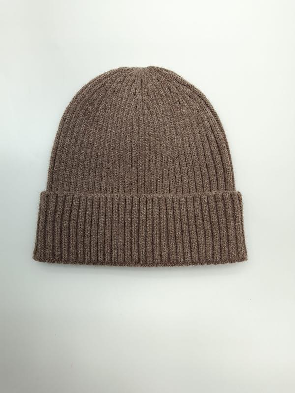 Taupe ribbed knit cuffed beanie hat laid flat on white background, soft fine-knit wool blend winter cap
