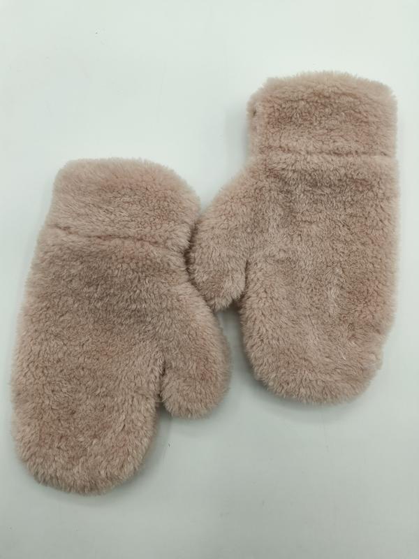 Pair of blush pink fluffy faux fur winter mittens laid flat on white background