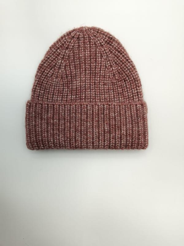 Flat lay of a dusty rose marl chunky ribbed knit beanie hat with folded cuff on white background